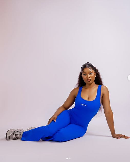 Woman seated in blue jumpsuit